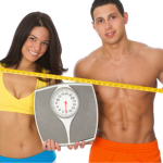 fit couple holding scale